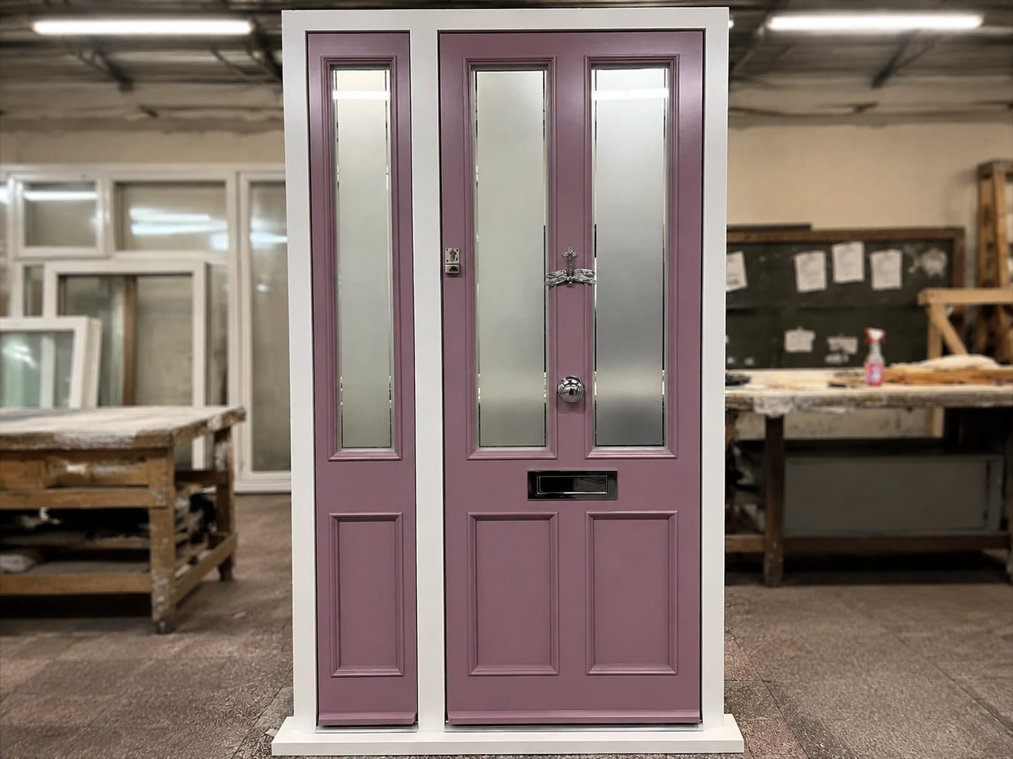 Dusty pink timber door with obscured glazed panels and side lights, photographed in the workshop