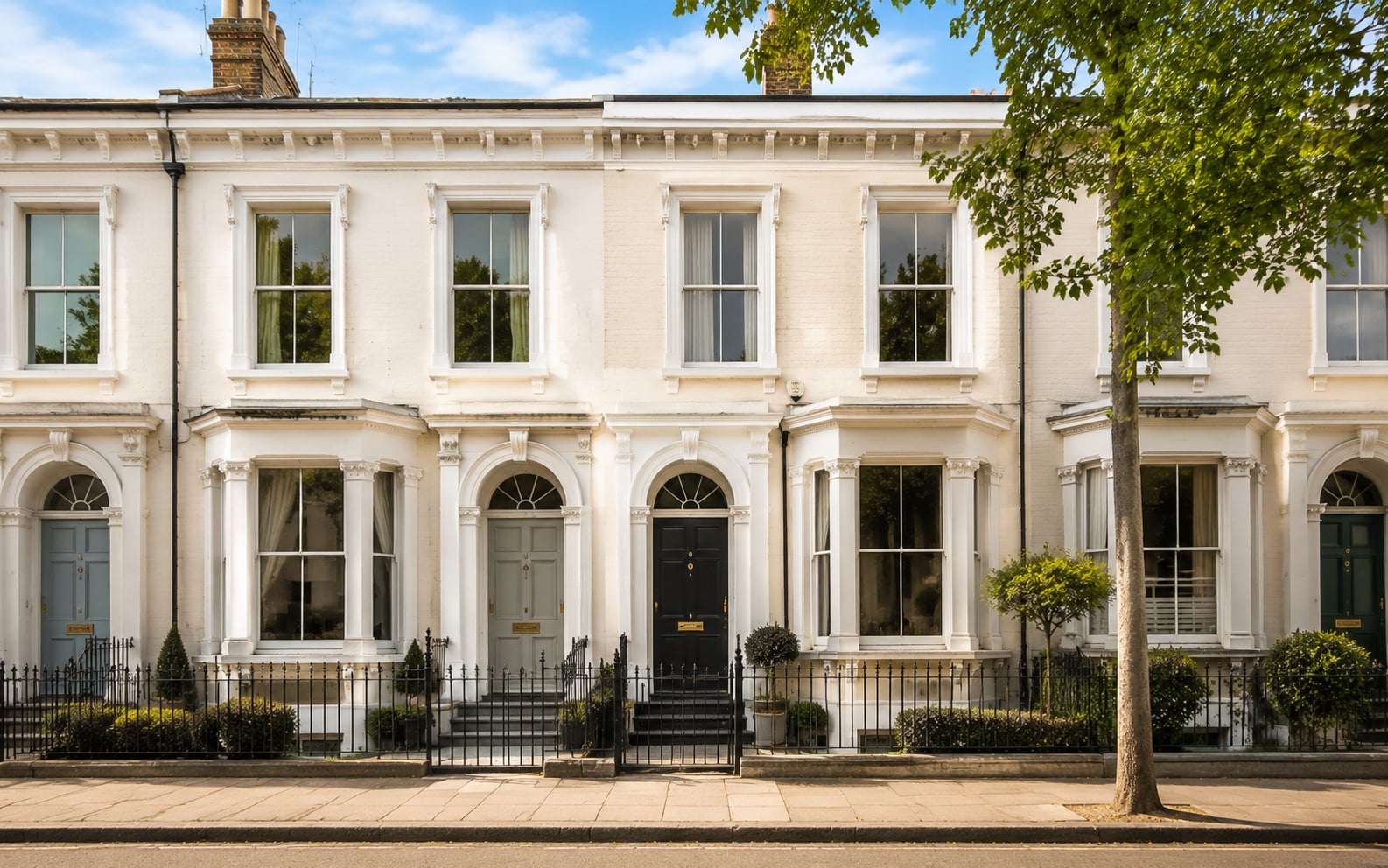 White stuccoed Victorian terrace in Leamington Spa with white timber sash windows and iron railings